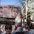 A woman holds a sign reading, "Justice for all. No to silence" as journalists, friends and relatives pay tribute to slain Mexican journalist Javier Valdez in May 2018