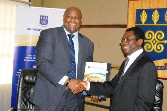 Prof. Kwame Offei,  Pro-Vice Chancellor in charge of Academic and Student Affairs, and Mr. Leslie Nelson, Chief Executive Officer, GE, Ghana in a handshake after signing the MOU