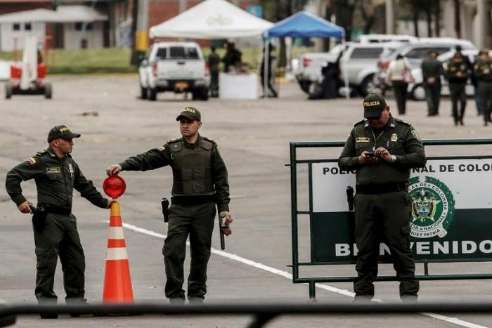 Police officers stand at General Santander Police Academy in Bogota, a day after a deadly car bomb attack