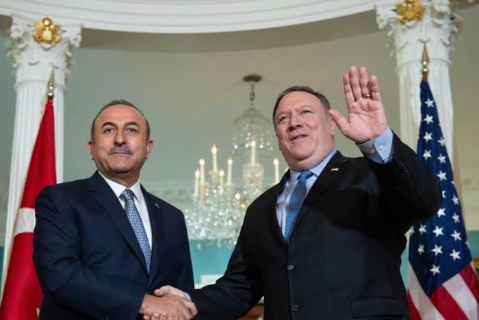 Turkish Foreign Minister Mevlut Cavusoglu (L, pictured November 2018) said after a phone call with US Secretary of State Mike Pompeo that he finds "correct his statement about the removal [from Syria] of the elements that concern Turkey"