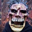A protester in Mexico City commemorates the first anniversary of the disappearance of the 43 students from Ayotzinapa. Protesters have tackled the issue in striking and original visual ways — such as this figure, clad in a mask crowned with crucifixes