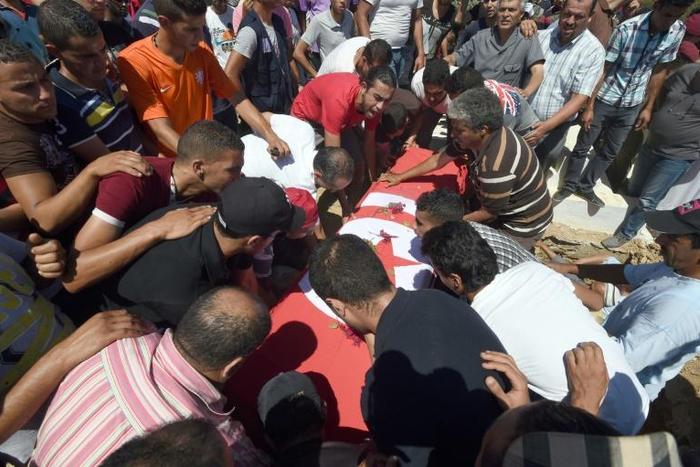 Tunisian mourners carry the coffin of a soldier who was killed by militants in a July 2014 attack