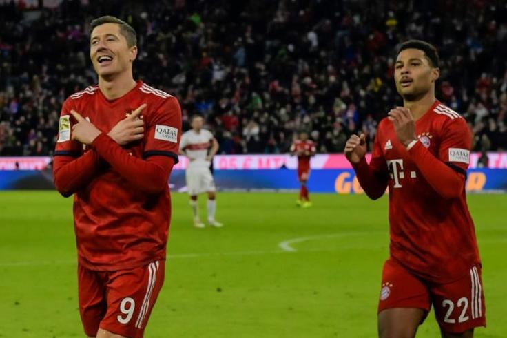 Robert Lewandowski (L) celebrates scoring Bayern Munich's final goal in Sunday's 4-1 win at home to VfB Stuttgart to stay six points behind leaders Borussia Dortmund in the Bundesliga title race.
