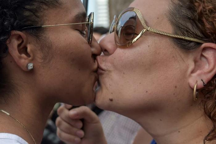 A score of protesters shouted "Love is love! Love is love!" many of them kissing outside the huge Del Carmen church, symbolic for Panamanians as a gathering point for protests against 1980s dictator Manuel Noriega