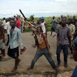 A protestor holds up a dead owl attached to a stick, intended to denigrate the ruling party whose emblem is an eagle, during a protest in Buterere neighbourhood of Bujumbura, Burundi May 12, 2015.    REUTERS/Goran Tomasevic