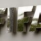 Water flows over the FIFA logo in front of the FIFA headquarters during heavy rainfall in Zurich July 22, 2011. REUTERS/Arnd Wiegmann