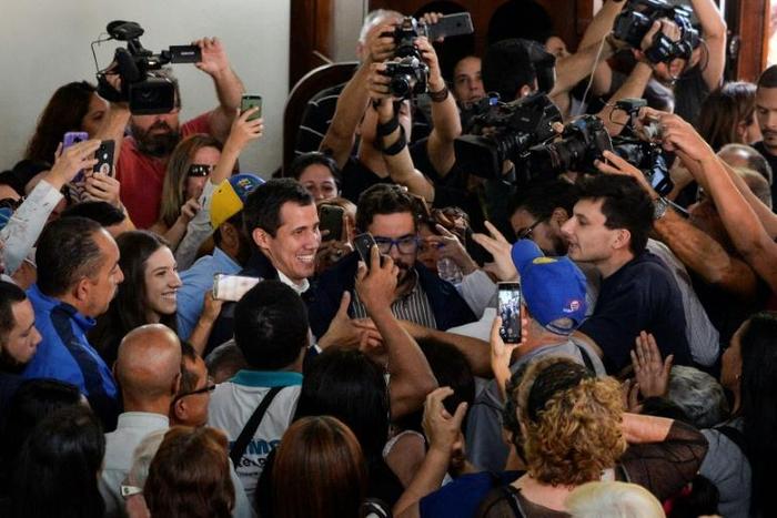 Venezuela's self-proclaimed acting president Juan Guaido leaves a church mass in Caracas