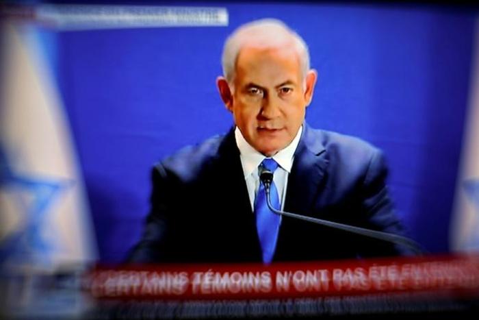 This picture taken from I-24 television shows Israeli Prime Minister Benjamin Netanyahu delivering a statement live at the prime minister's office in Jerusalem on January 07, 2019