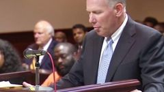 Rick Ross seated in the court while his attorney spoke on the bail bond