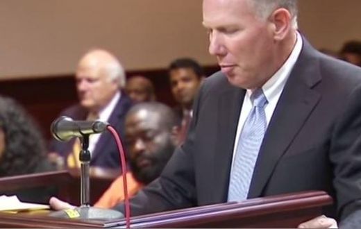 Rick Ross seated in the court while his attorney spoke on the bail bond