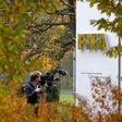A cameraman stands in front of FIFA's headquarters in Zurich, Switzerland October 8, 2015. REUTERS/Arnd Wiegmann