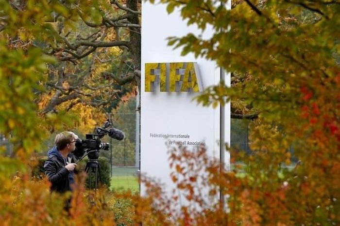 A cameraman stands in front of FIFA's headquarters in Zurich, Switzerland October 8, 2015. REUTERS/Arnd Wiegmann