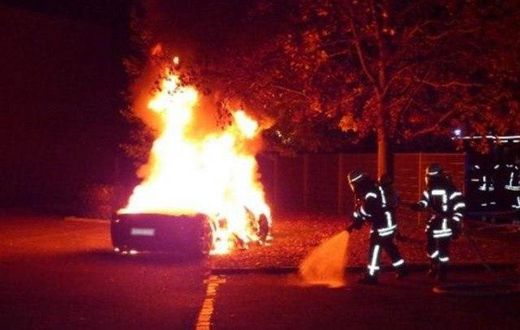 The Ferrari on fire in front of a brothel