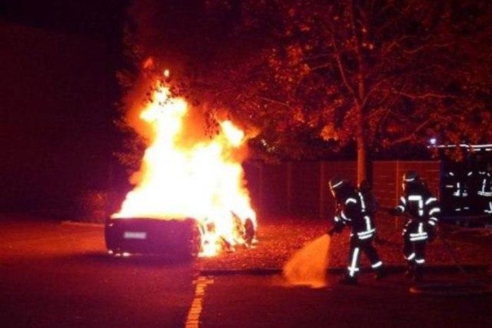 The Ferrari on fire in front of a brothel