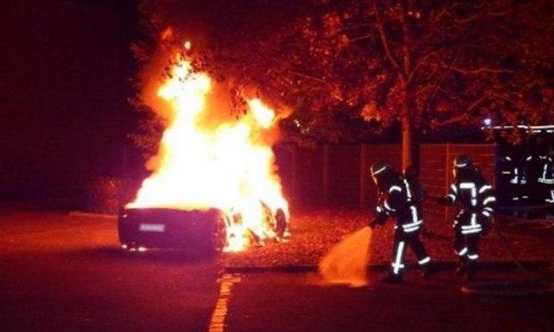 The Ferrari on fire in front of a brothel