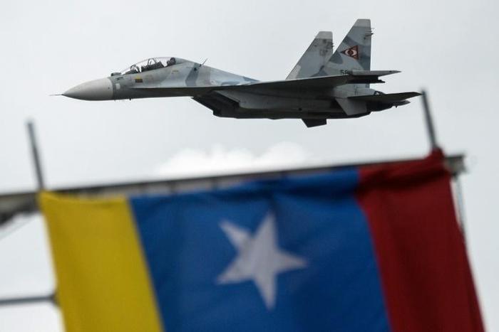 In this file picture taken on July 5, 2017, a Russian-made Venezuelan Air Force Sukhoi Su-30MKV multirole strike fighter overflies a military parade in Caracas
