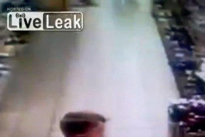 An unidentified Russian boy has been caught on camera taking a poop in the middle of a supermarket aisle.