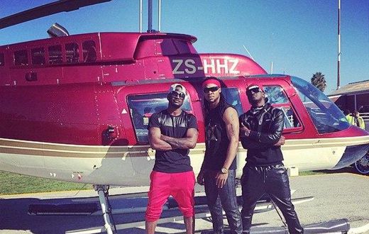 Psquare and Flavour in front of a chopper at the music video shoot