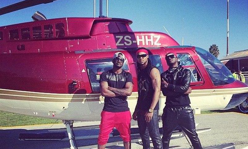 Psquare and Flavour in front of a chopper at the music video shoot