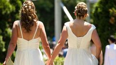 ___3950729___https:______static.pulse.com.gh___webservice___escenic___binary___3950729___2015___7___8___11___Cheryl-Taylor-and-Jennifer-Smith-hold-hands-as-they-arrive-for-the-Grand-Pride-Wedding-a-mass-gay-wedding-at-Casa-Loma-in-Toronto-Canada-on-Jun...