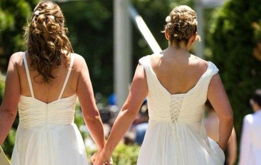 ___3950729___https:______static.pulse.com.gh___webservice___escenic___binary___3950729___2015___7___8___11___Cheryl-Taylor-and-Jennifer-Smith-hold-hands-as-they-arrive-for-the-Grand-Pride-Wedding-a-mass-gay-wedding-at-Casa-Loma-in-Toronto-Canada-on-Jun...