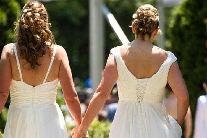 ___3950729___https:______static.pulse.com.gh___webservice___escenic___binary___3950729___2015___7___8___11___Cheryl-Taylor-and-Jennifer-Smith-hold-hands-as-they-arrive-for-the-Grand-Pride-Wedding-a-mass-gay-wedding-at-Casa-Loma-in-Toronto-Canada-on-Jun...