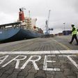 A man walks at a container port in Abidjan October 4, 2012. REUTERS/Thierry Gouegnon