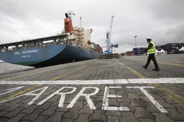 A man walks at a container port in Abidjan October 4, 2012. REUTERS/Thierry Gouegnon