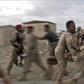 Loyalist Yemeni troops rush a wounded comrade for treatment after a rebel drone strike that killed six and wounded 12, including top brass
