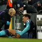 Tottenham midfielder Dele Alli receives medical attention at Craven Cottage