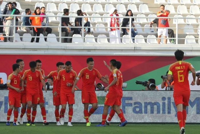 China's players celebrate scoring in their narrow win 2-1 over Kyrgyzstan in the Asian Cup