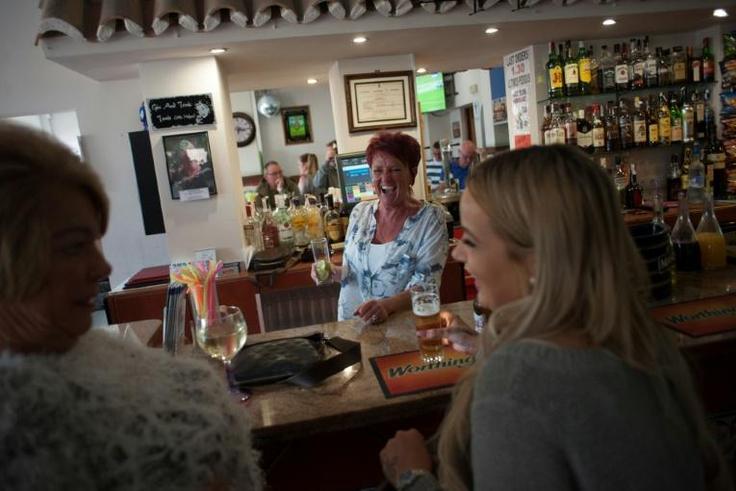People drink in a bar in Benalmadena, southern Spain, in March 2017 -- Spain is the number one destination for British nationals living outside Britain, ahead of France and Ireland