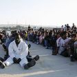 Migrants rest after disembarking in the Sicilian harbour of Augusta, Italy, June 23, 2015.   REUTERS/Antonio Parrinello