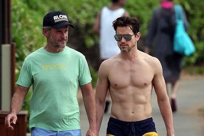 A shirtless Matt Bomer and husband Simon Halls in Hawaii