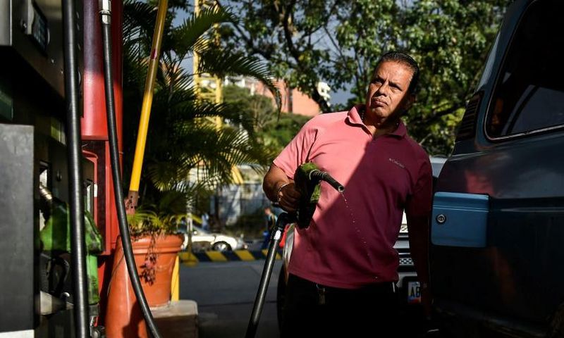 A man pumps fuel at a gas station in Caracas, on January 29, 2019