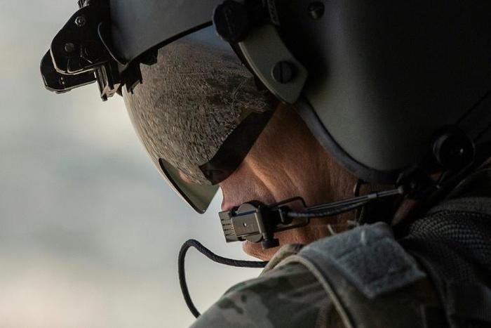 A partial view of the Iraqi capital is reflected in the visor of a US army helicopter crew member as he looks out of a Chinook helicopter over Baghdad on January 9, 2019
