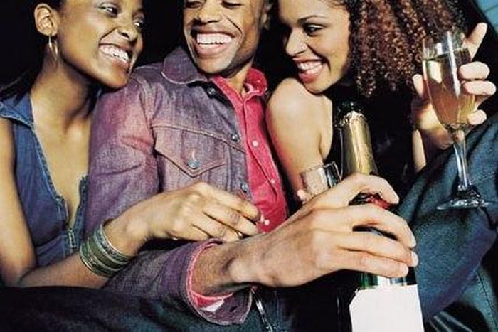 A man partying with two ladies