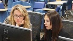 Emily Reid with a student at Girls Who Code
