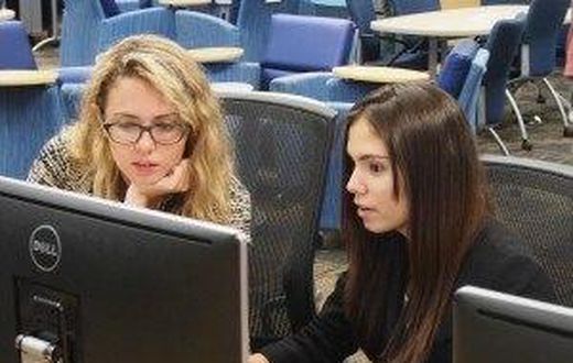 Emily Reid with a student at Girls Who Code