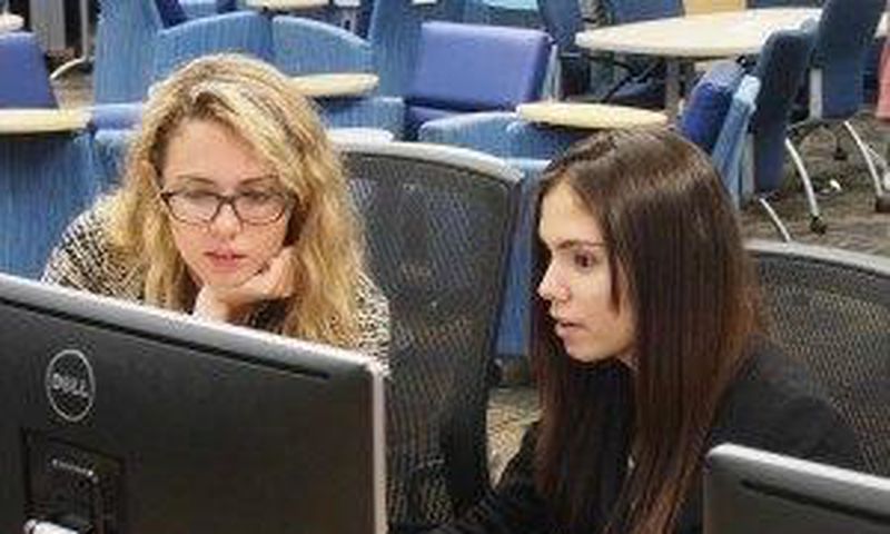 Emily Reid with a student at Girls Who Code