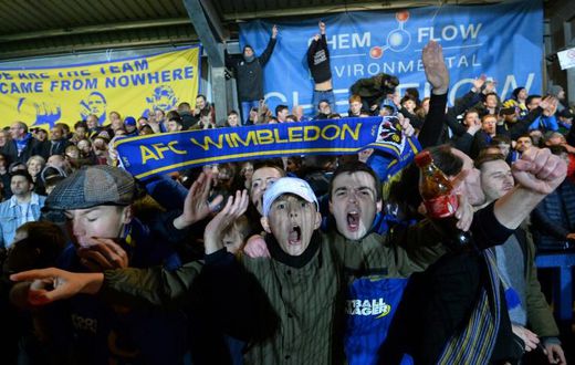Up for the Cup: AFC Wimbledon fans celebrate their 4-2 victory over West Ham in the fourth round of the FA Cup