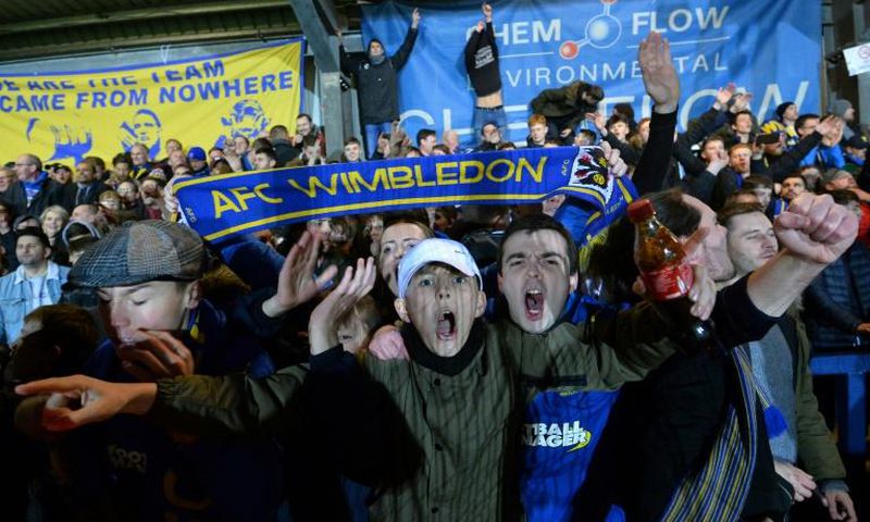 Up for the Cup: AFC Wimbledon fans celebrate their 4-2 victory over West Ham in the fourth round of the FA Cup