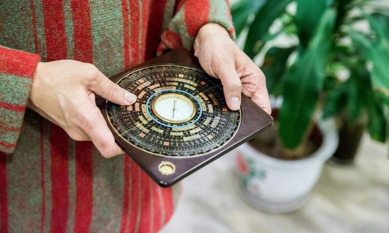 A luopan, or Chinese compass, is used by Chinese feng shui masters to find the right alignment to promote health and wealth