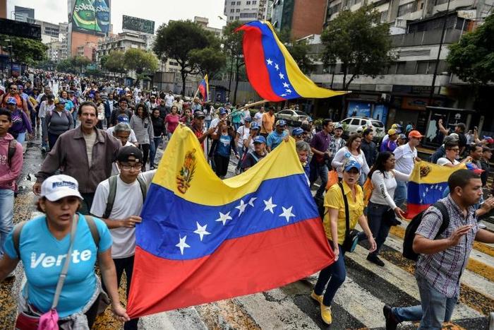 Venezuelan opposition supporters take part in a march on the anniversary of 1958 uprising that overthrew military dictatorship in Caracas on January 23, 2019