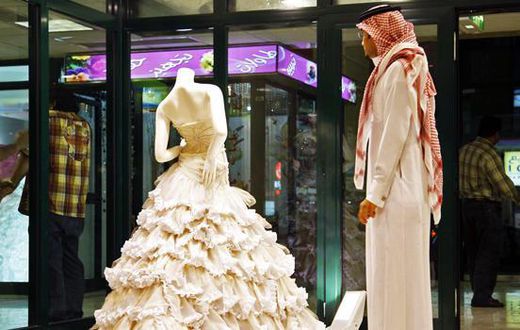 In this Aug. 3, 2008 file photo, a Saudi man stands in front of a wedding dress at a shop in Riyadh, Saudi Arabia.