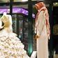 In this Aug. 3, 2008 file photo, a Saudi man stands in front of a wedding dress at a shop in Riyadh, Saudi Arabia.