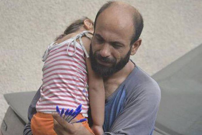 Single parent of two, Abdul and his daughter, Reem, as he hawks pens in Beirut
