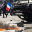 An UberPOP car was overturned by protesters who also clashed with riot police.