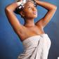 African American woman in towel shampooing her hair