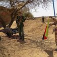 A fighter with the Tuareg separatist group MNLA (National Movement for the Liberation of Azawad) brandishes a separatist flag for the region they call Azawad outside the local regional assembly, where members of the rebel group met with the Malian army...